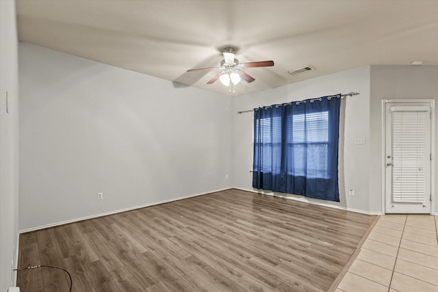 empty room with hardwood / wood-style flooring and ceiling fan