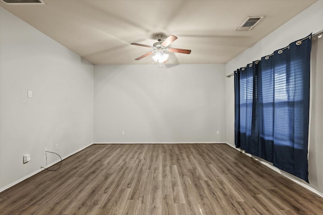 spare room with hardwood / wood-style flooring and ceiling fan