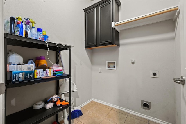 laundry room featuring electric dryer hookup, cabinets, hookup for a gas dryer, washer hookup, and light tile patterned floors