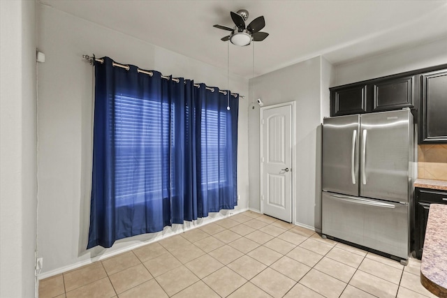 kitchen with stainless steel fridge, light tile patterned flooring, and ceiling fan