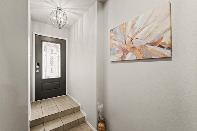 entryway with light tile patterned floors and a notable chandelier