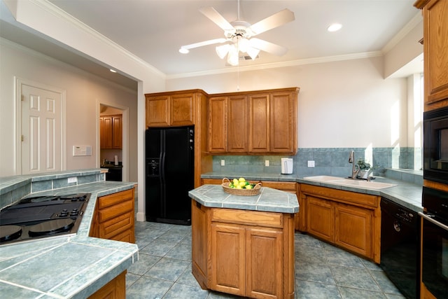 kitchen featuring black appliances, crown molding, sink, ceiling fan, and a kitchen island