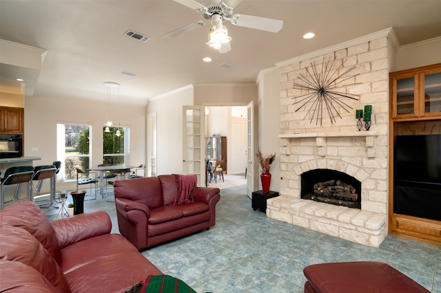 living room featuring a fireplace, ceiling fan, and ornamental molding