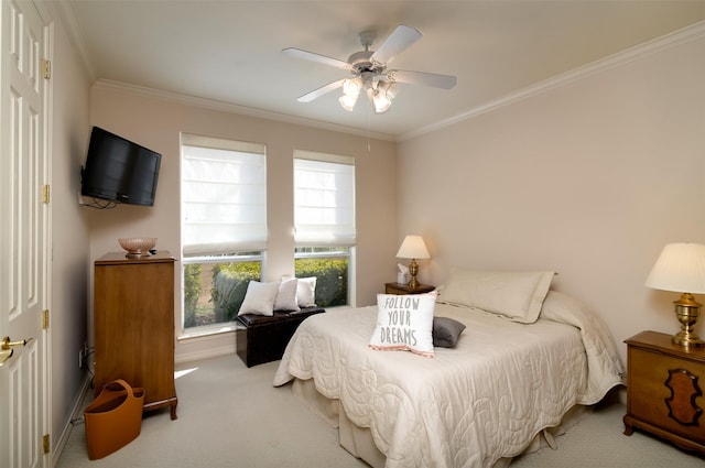 carpeted bedroom featuring ceiling fan and ornamental molding