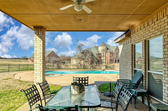 view of patio / terrace with a fenced in pool and ceiling fan