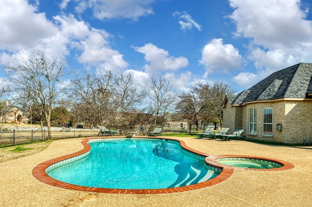 view of swimming pool featuring an in ground hot tub and a patio