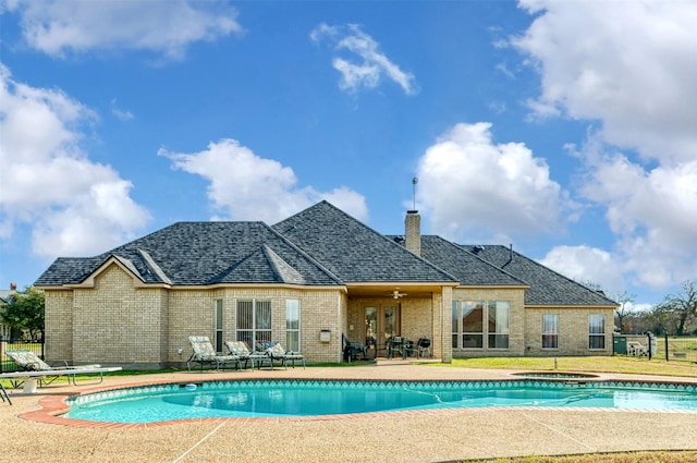 view of swimming pool featuring ceiling fan and a patio area