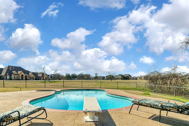 view of swimming pool featuring a diving board, an in ground hot tub, and a patio