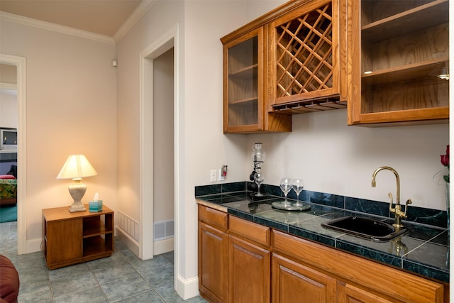 kitchen with crown molding and sink