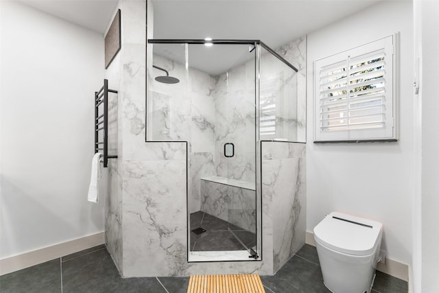 bathroom with a marble finish shower, baseboards, toilet, and tile patterned flooring