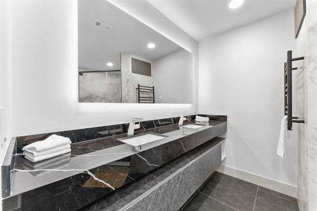 full bathroom featuring visible vents, double vanity, baseboards, recessed lighting, and a sink