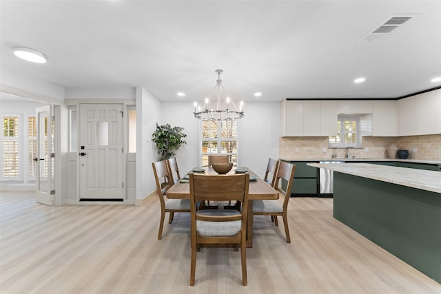 dining area with a chandelier, visible vents, recessed lighting, and light wood-style floors