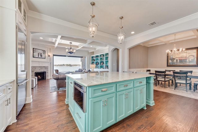 kitchen with beamed ceiling, decorative light fixtures, a fireplace, and coffered ceiling