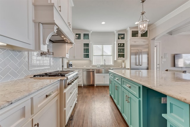 kitchen with decorative backsplash, decorative light fixtures, appliances with stainless steel finishes, and green cabinetry