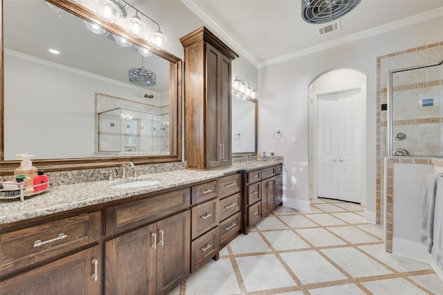 bathroom with vanity, an enclosed shower, and crown molding