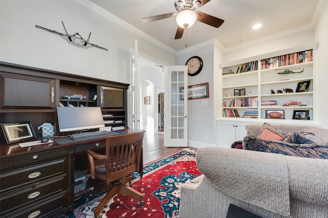 office space featuring french doors, built in shelves, ceiling fan, crown molding, and hardwood / wood-style flooring