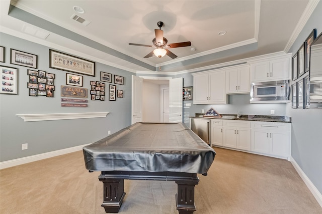 game room with ceiling fan, crown molding, light colored carpet, a tray ceiling, and pool table