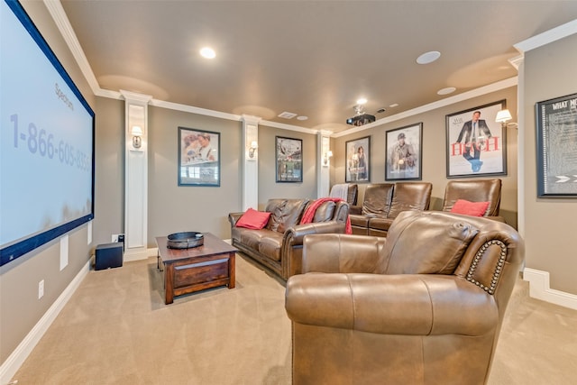 cinema room featuring light colored carpet, crown molding, and decorative columns