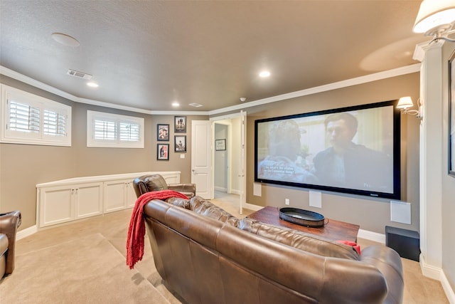 carpeted home theater featuring crown molding