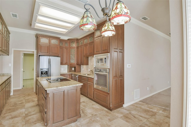 kitchen featuring sink, stainless steel appliances, pendant lighting, a kitchen island, and ornamental molding