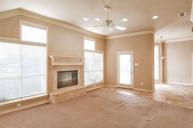 unfurnished living room featuring light carpet, ceiling fan with notable chandelier, crown molding, and a premium fireplace