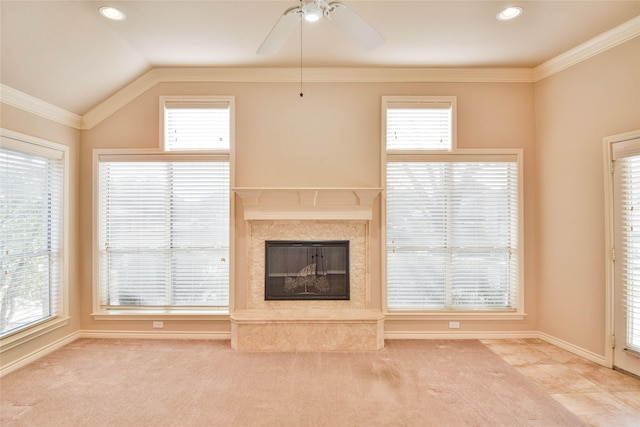 unfurnished living room with carpet, lofted ceiling, ornamental molding, and a high end fireplace