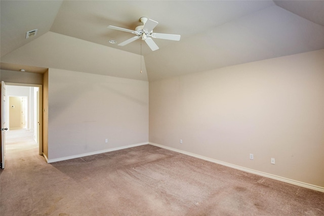 carpeted spare room featuring ceiling fan and vaulted ceiling