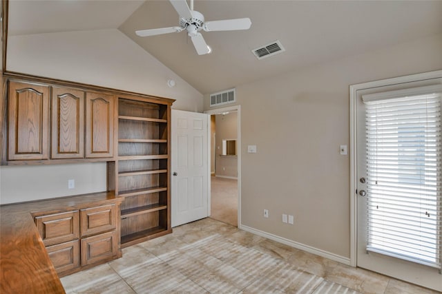 unfurnished office with a wealth of natural light, light tile patterned floors, ceiling fan, and lofted ceiling