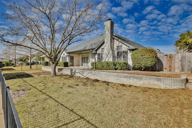 view of side of property with a yard