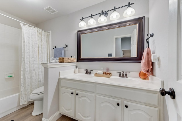 full bathroom with shower / bath combination with curtain, vanity, hardwood / wood-style flooring, and toilet