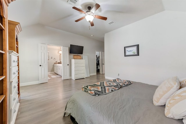 bedroom with connected bathroom, ceiling fan, vaulted ceiling, and light wood-type flooring