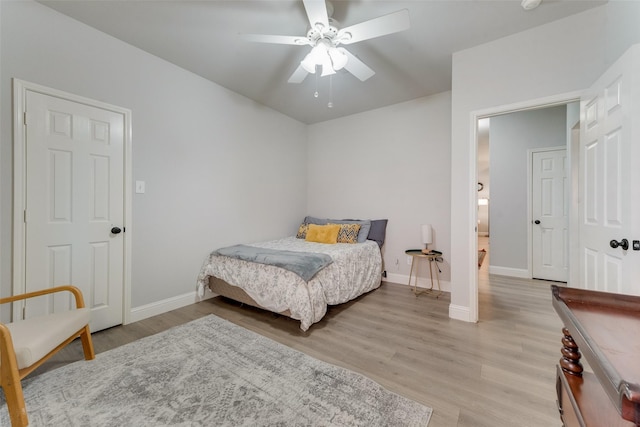 bedroom with ceiling fan and light wood-type flooring