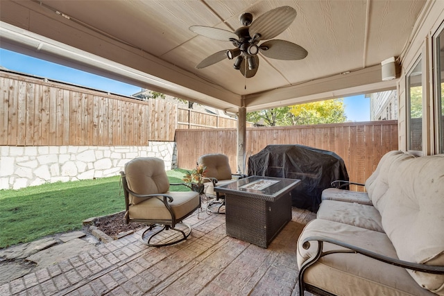 view of patio with area for grilling, a fire pit, and ceiling fan