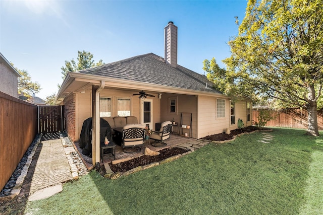 back of property featuring outdoor lounge area, a patio, ceiling fan, and a lawn