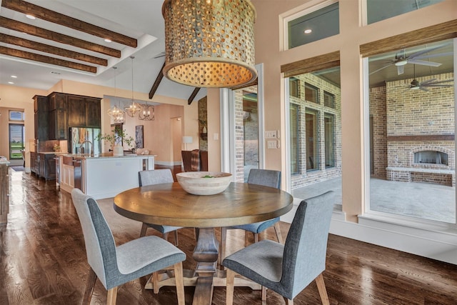 dining area with beamed ceiling, dark hardwood / wood-style floors, and ceiling fan with notable chandelier