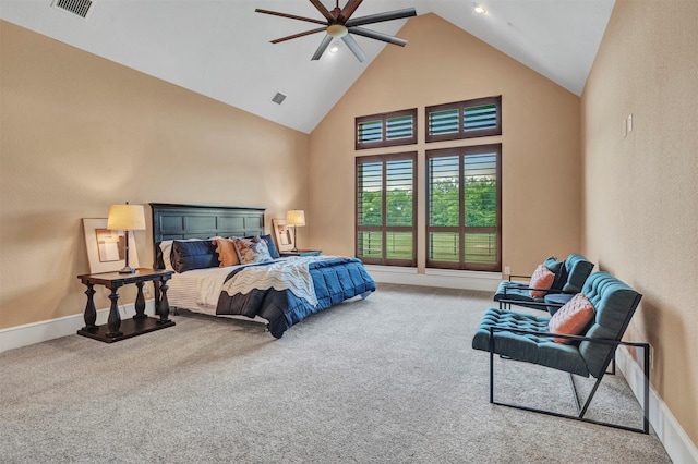 carpeted bedroom with ceiling fan and high vaulted ceiling