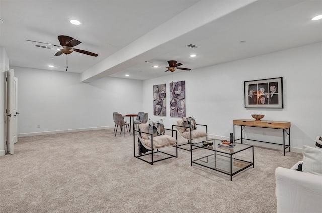 carpeted living room with ceiling fan