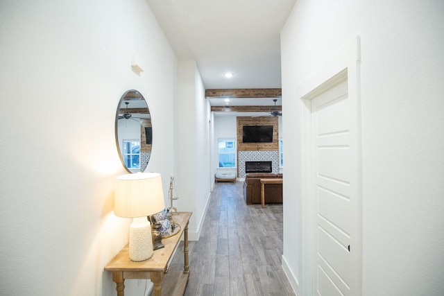 corridor featuring recessed lighting, beam ceiling, baseboards, and wood finished floors