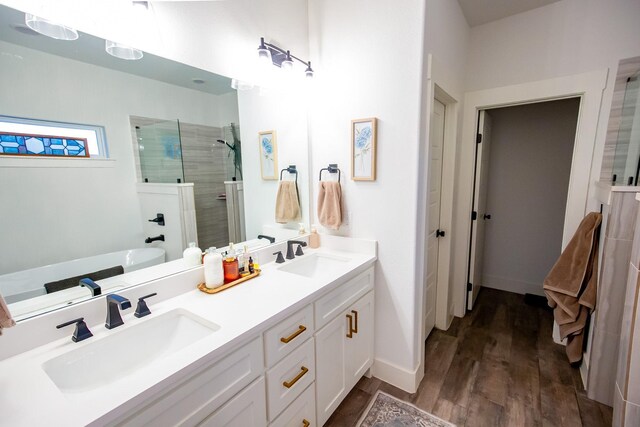 bathroom with vanity, wood-type flooring, and independent shower and bath