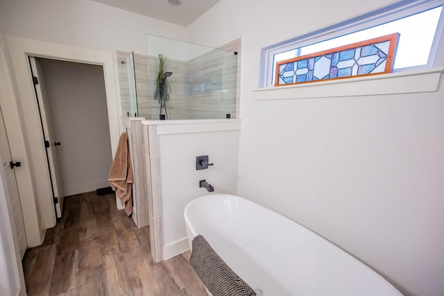 bathroom featuring hardwood / wood-style flooring and independent shower and bath