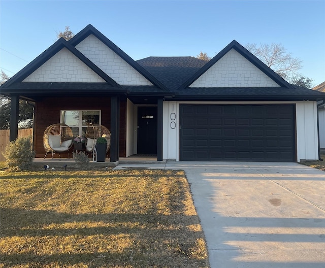 view of front of home with a front lawn and a garage