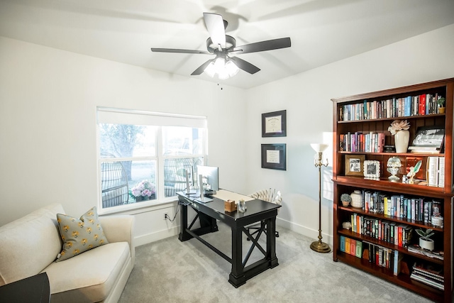 home office featuring light carpet and ceiling fan