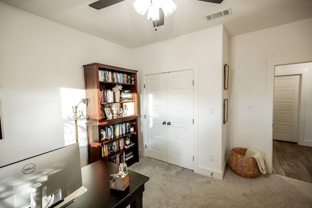 carpeted home office with ceiling fan