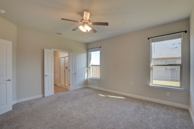 unfurnished room featuring light carpet and ceiling fan