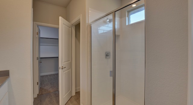 bathroom featuring hardwood / wood-style flooring and an enclosed shower