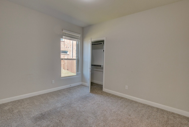 unfurnished bedroom with a closet and carpet