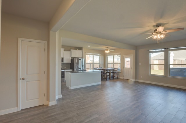 unfurnished living room with hardwood / wood-style floors and ceiling fan