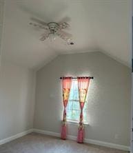 bonus room with ceiling fan and lofted ceiling