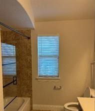 bathroom with tile patterned flooring, vanity, toilet, and a wealth of natural light