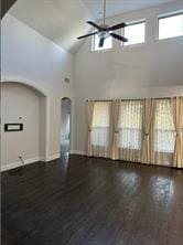 unfurnished room featuring ceiling fan, dark hardwood / wood-style flooring, and high vaulted ceiling